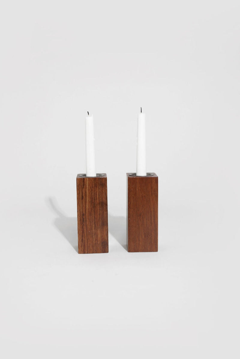 Pair of rectangular wood block candleholders with white candles
