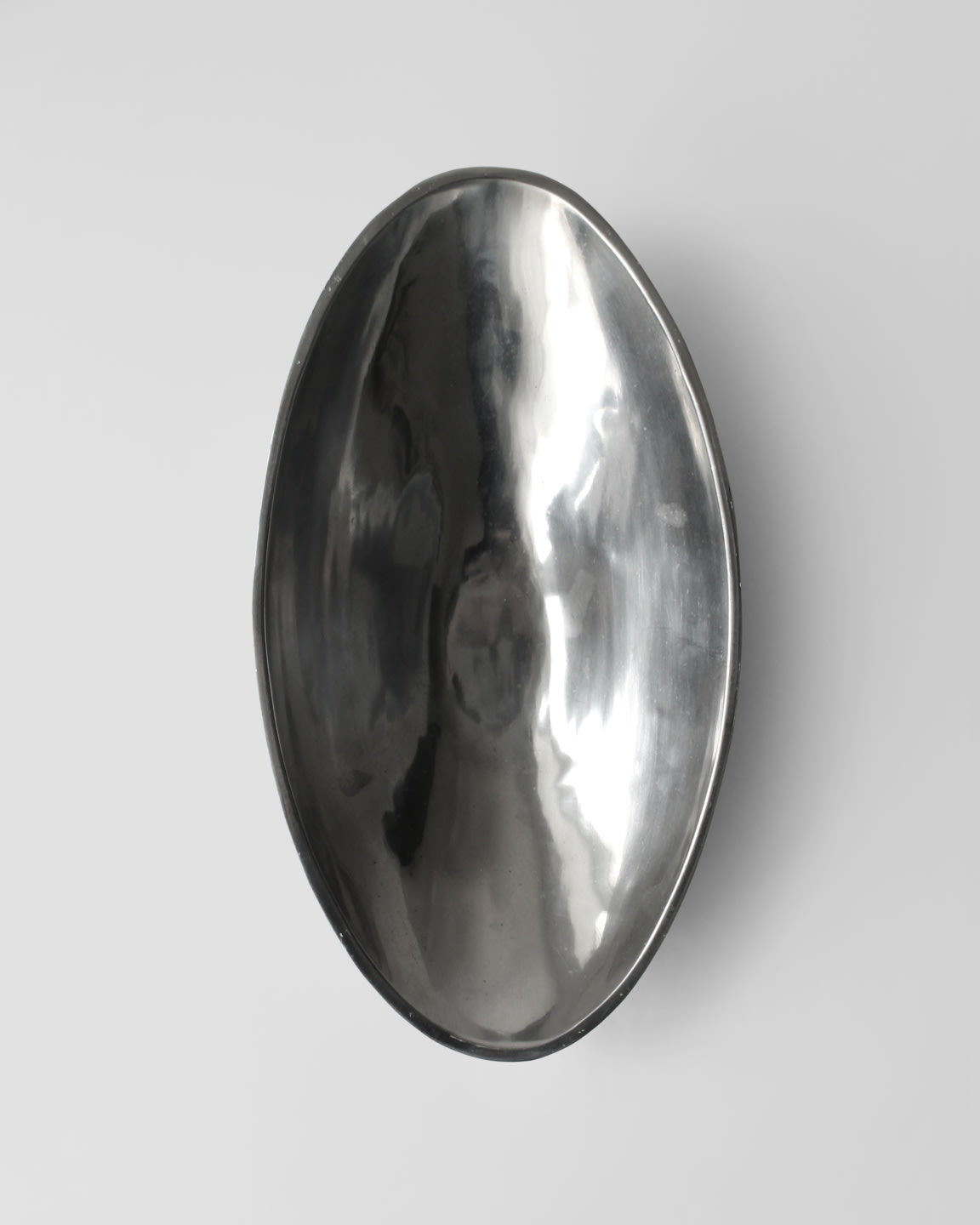 Polished aluminum oval serving bowl with hammered texture finish