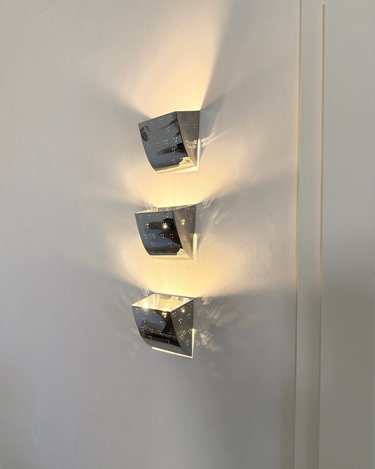 Jolene Wall Lamp - Polished Brass — close-up of polished brass surface with light reflections