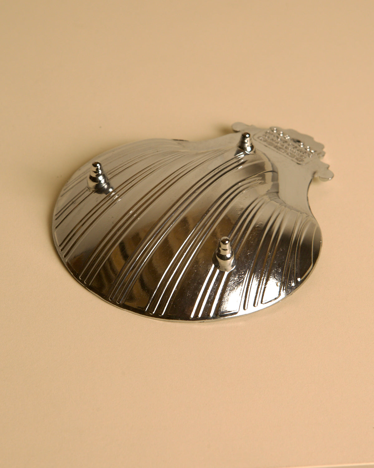 Silver-plated shell dish with ribbed pattern and three decorative studs