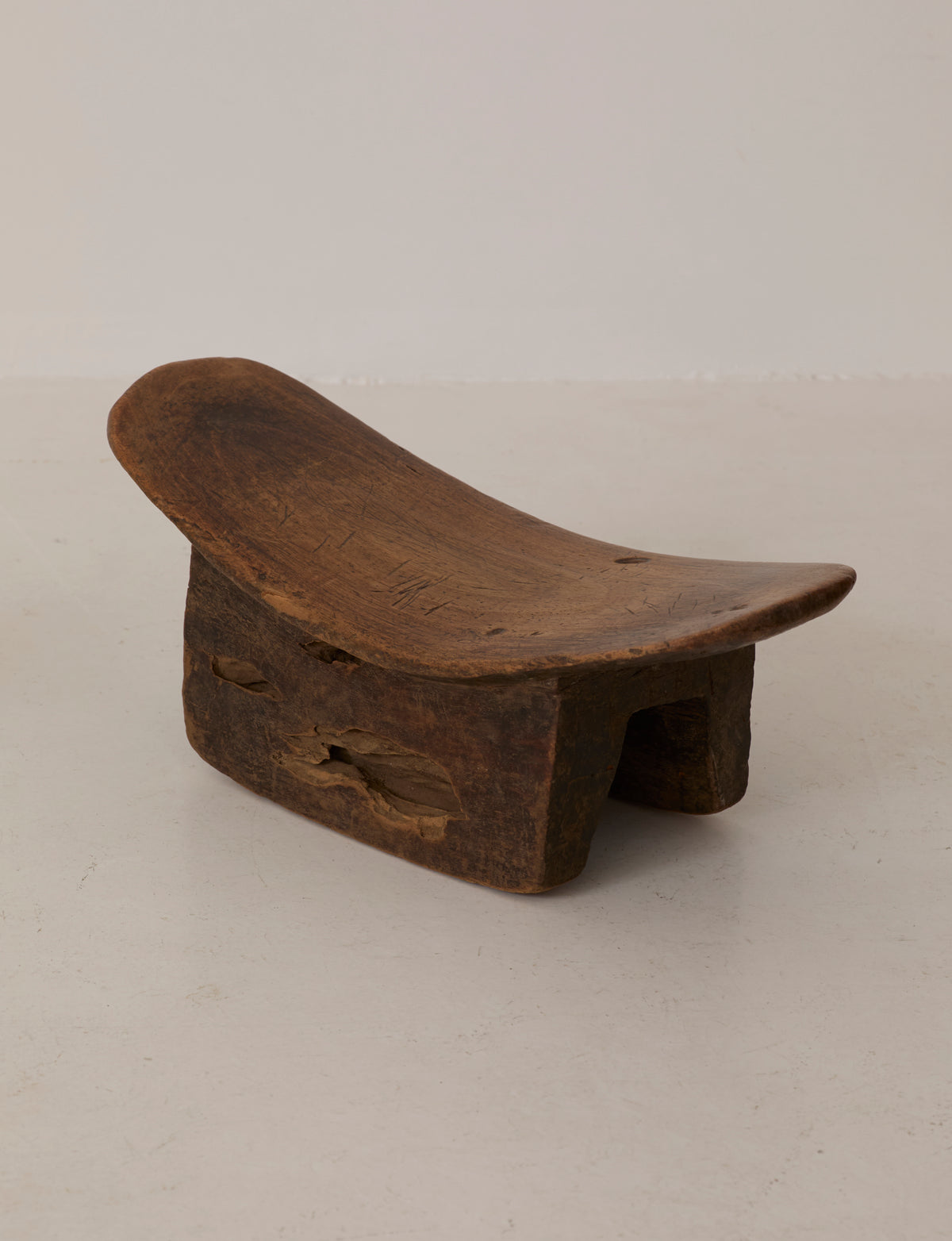 Mid-Century African Senufo Stool in Solid Wood — angled view on neutral background