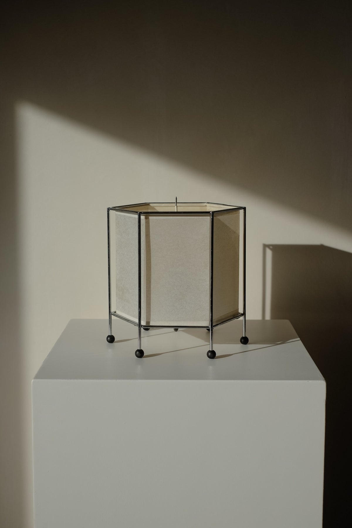 Japanese Rice Paper Table Lamp — angled view on white pedestal