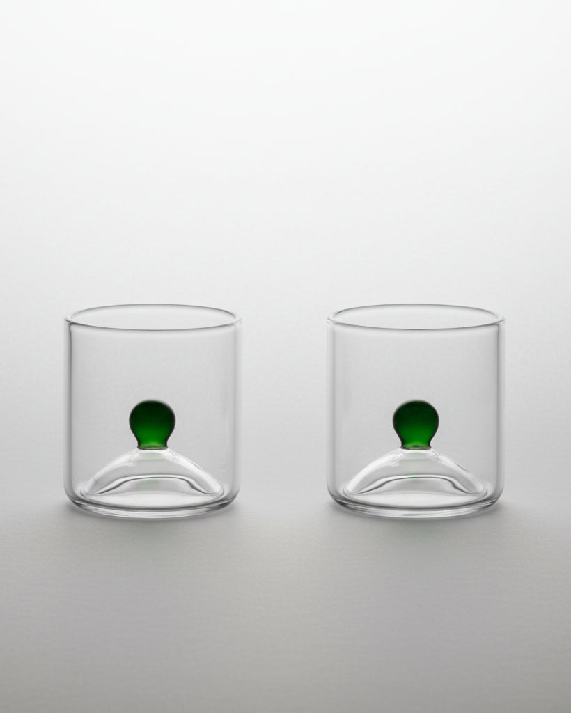 Two clear glass shot glasses with green sphere detail, Las Chicas duo