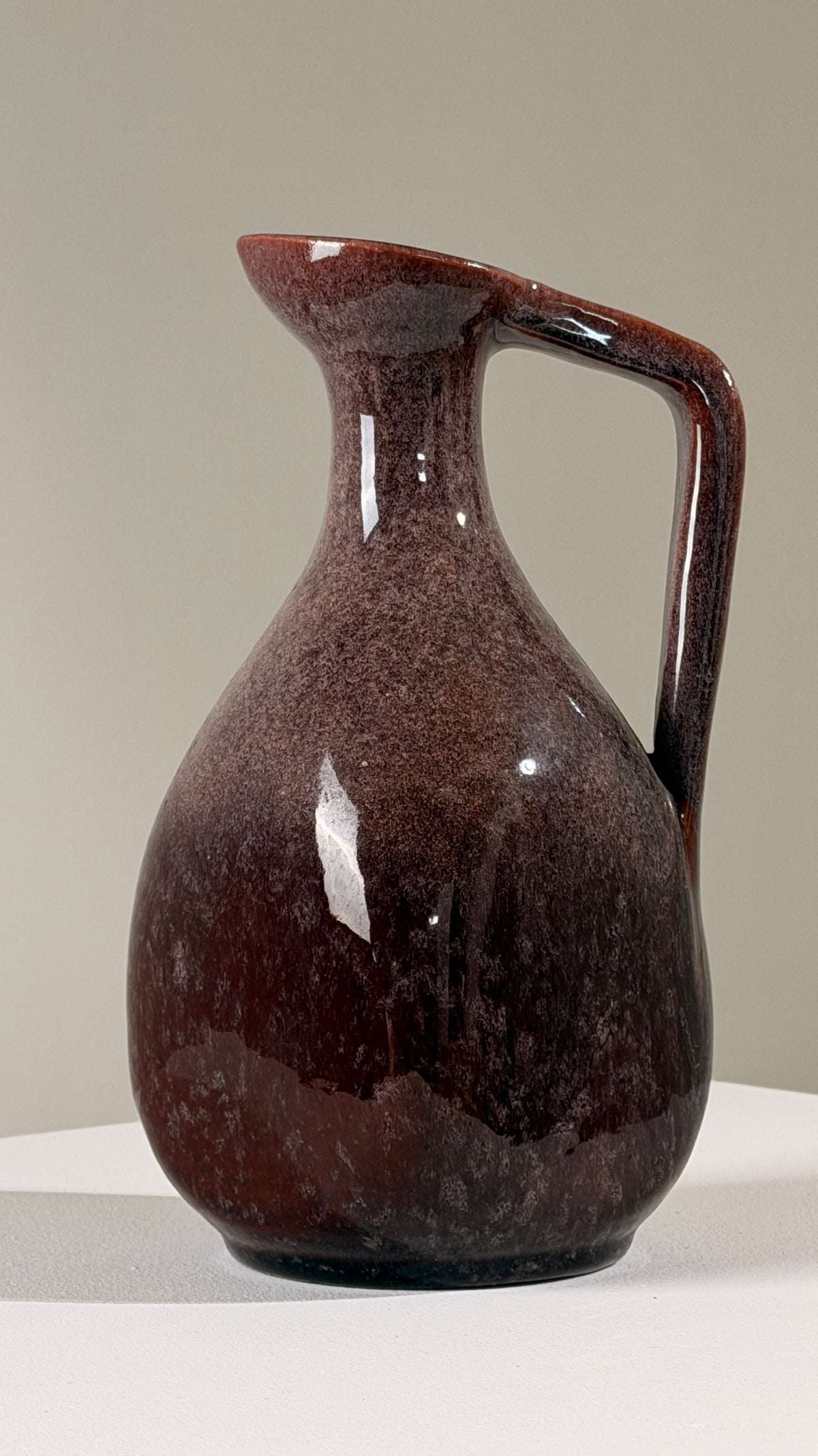 Ceramic pitcher by the Accolay potters, France, circa 1960 — side angle showing rich burgundy glaze