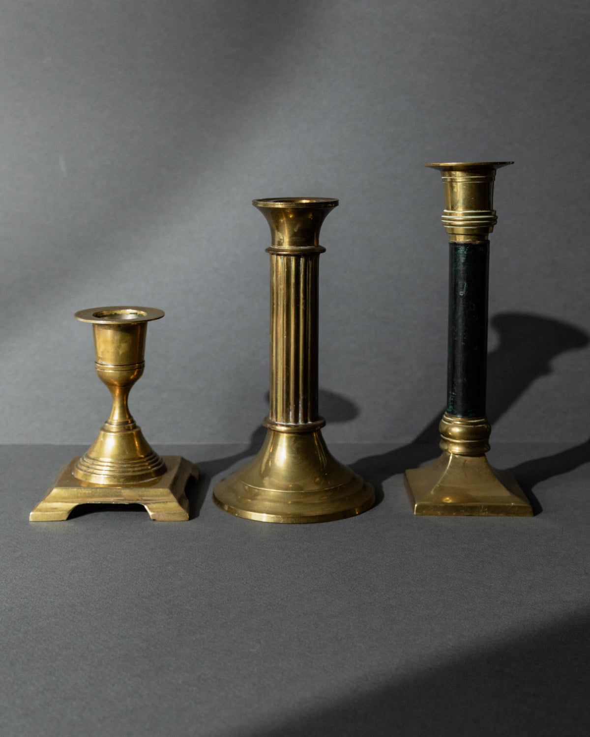 Vintage 1940s Brass Candleholders Set of 3, Mixed Shapes, Classic Antique Design — side angle showing three distinct brass de