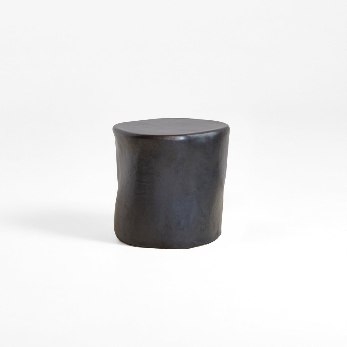 Ceramic Side Table (small) — angled view showing dark ceramic finish