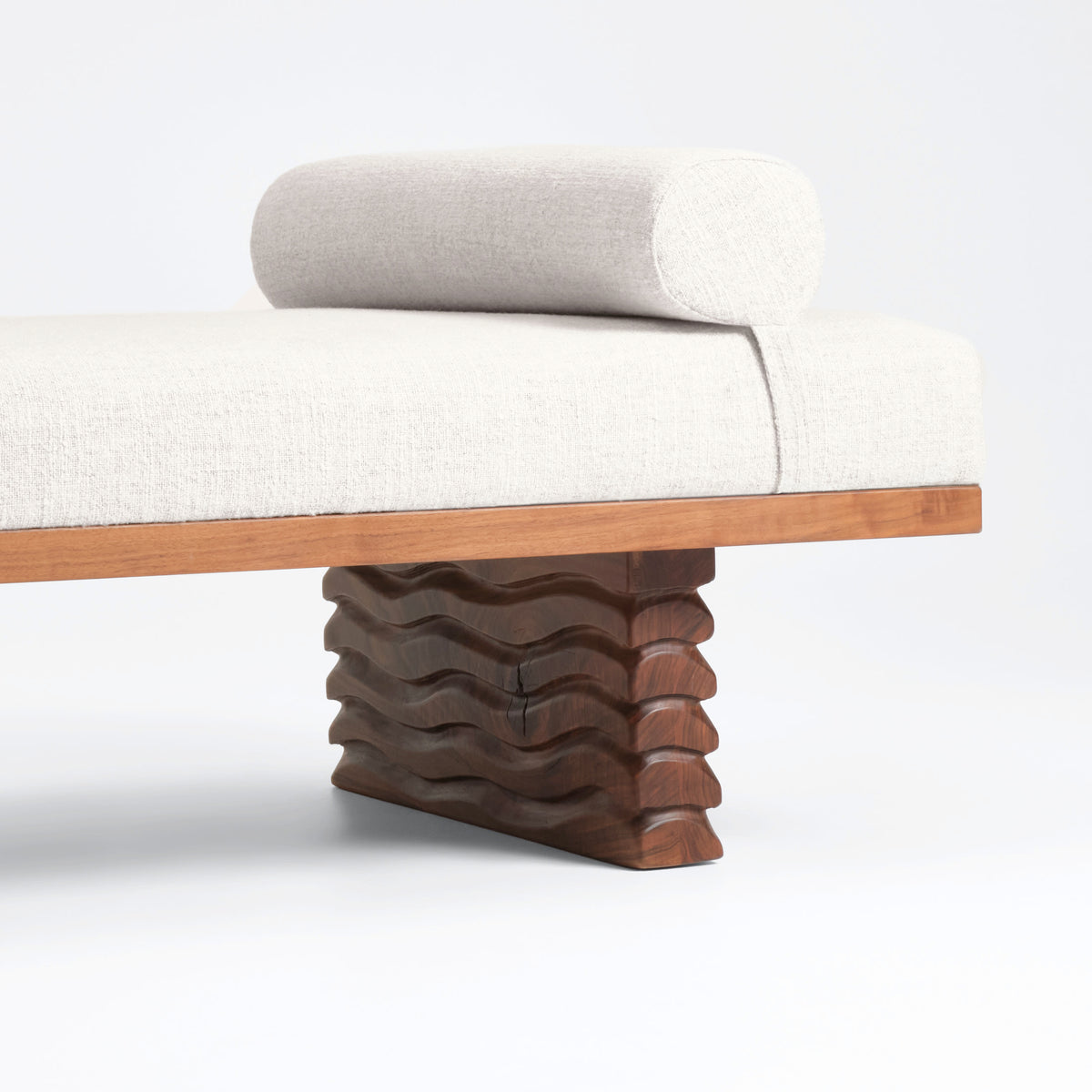 Nazaré Daybed — angled view showing textured wood base and fabric cushion