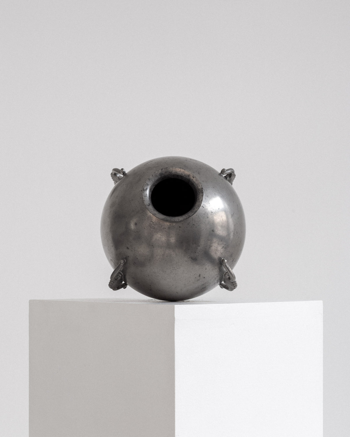 Spherical Art Deco Pewter Vase by C.G. Hallberg, 1934 — front view on white pedestal