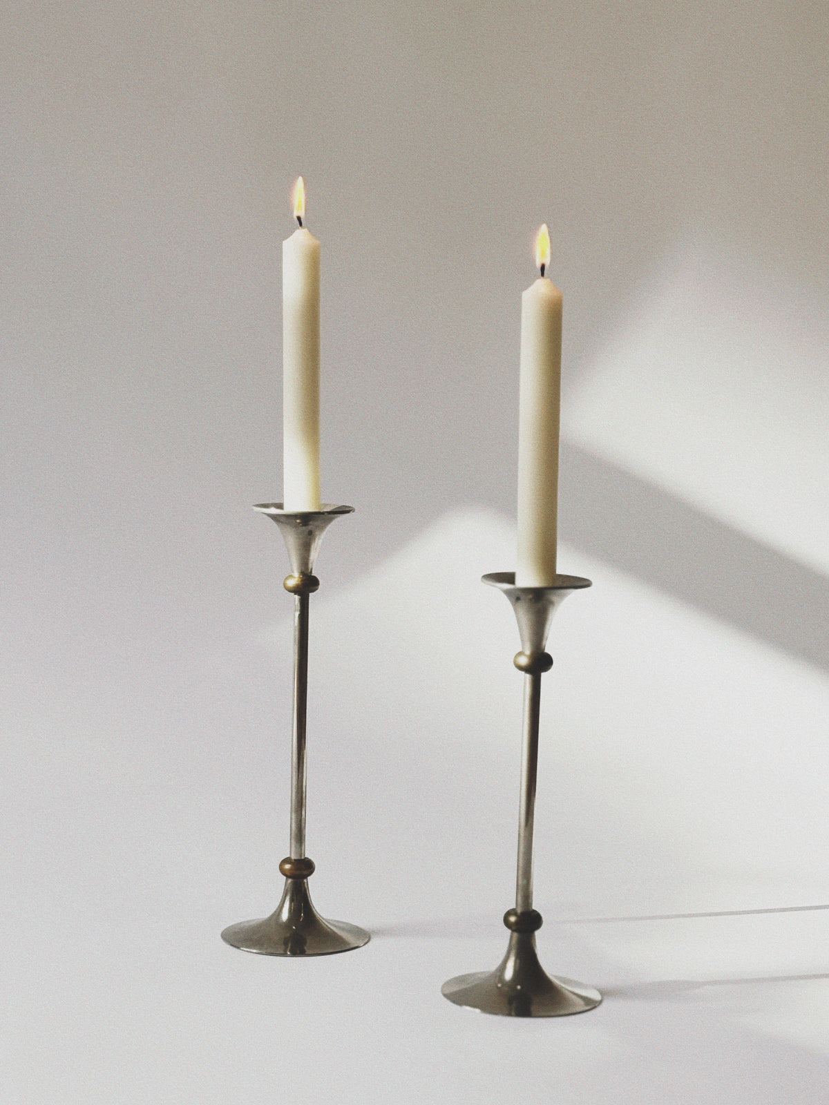 2 Metal Postmodern Candleholders — close-up of polished metal finish