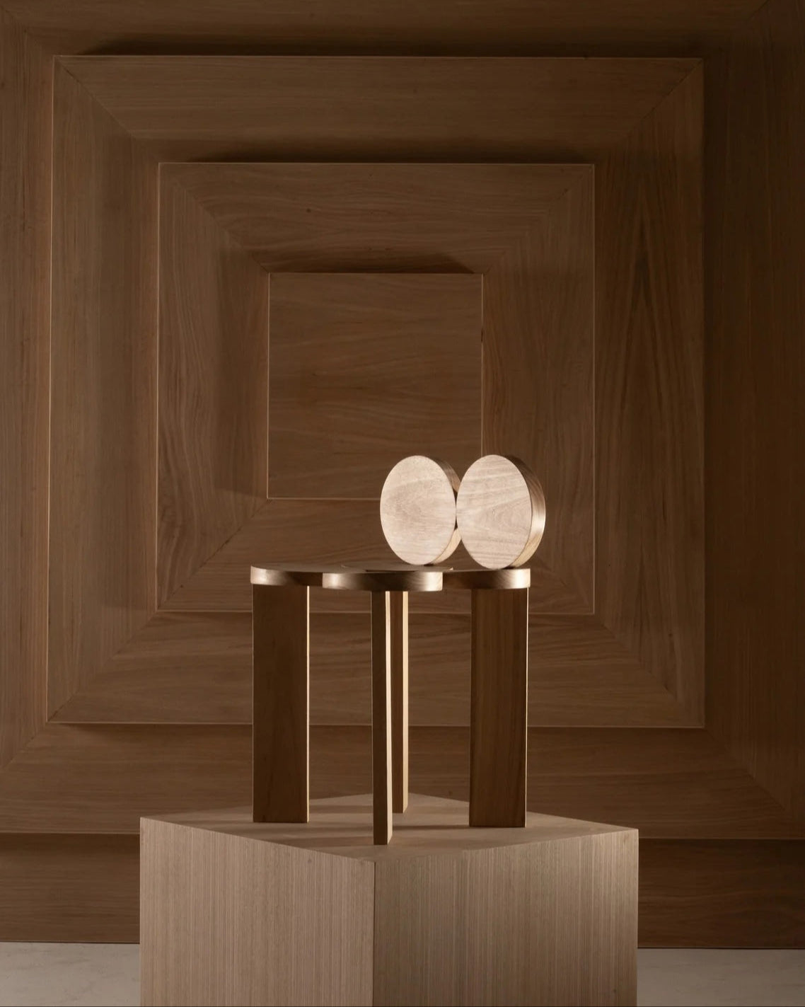 Cadeira 1 wooden chair on display pedestal showing geometric design