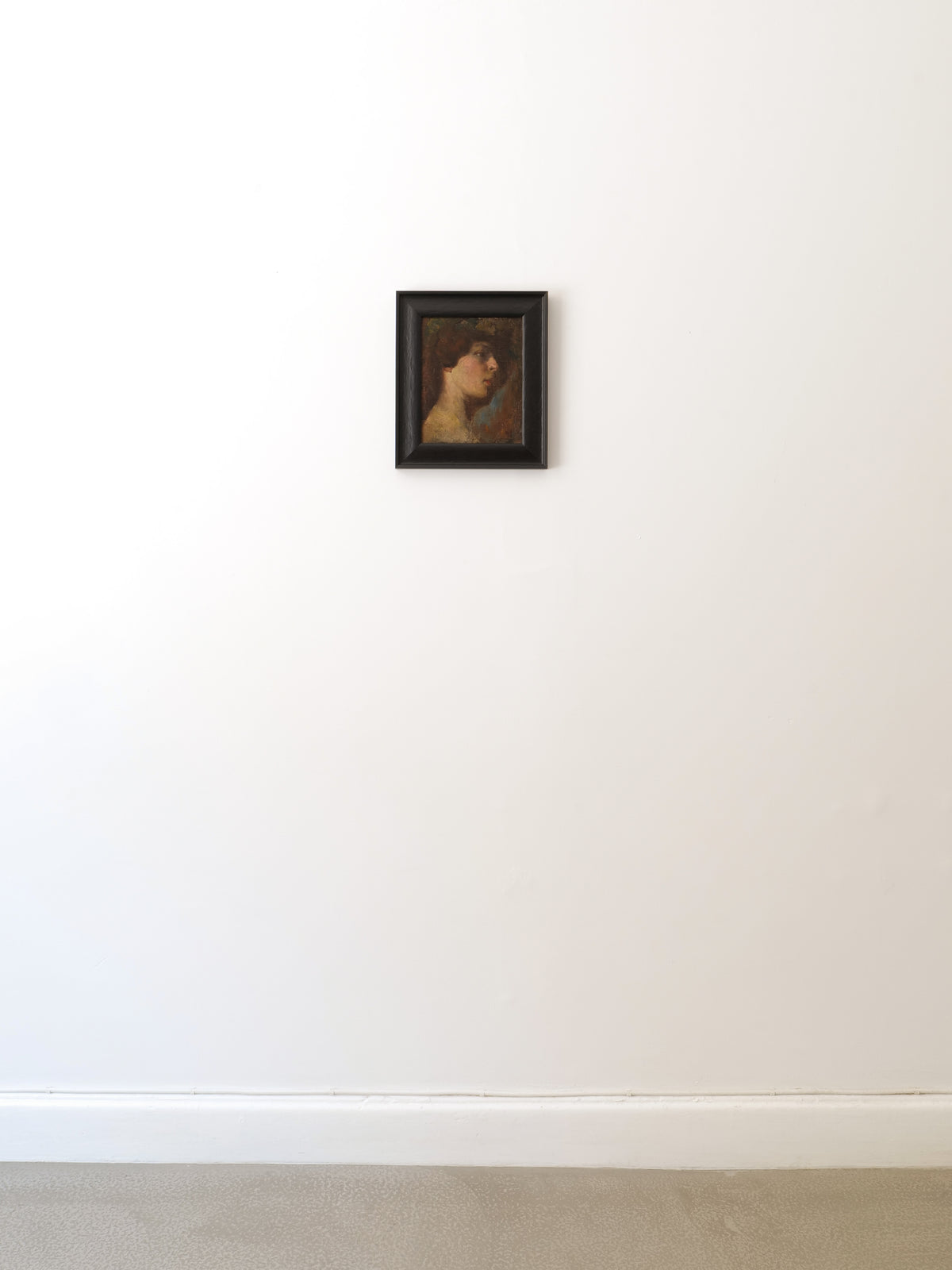 Victorian oil portrait painting in dark frame on white wall