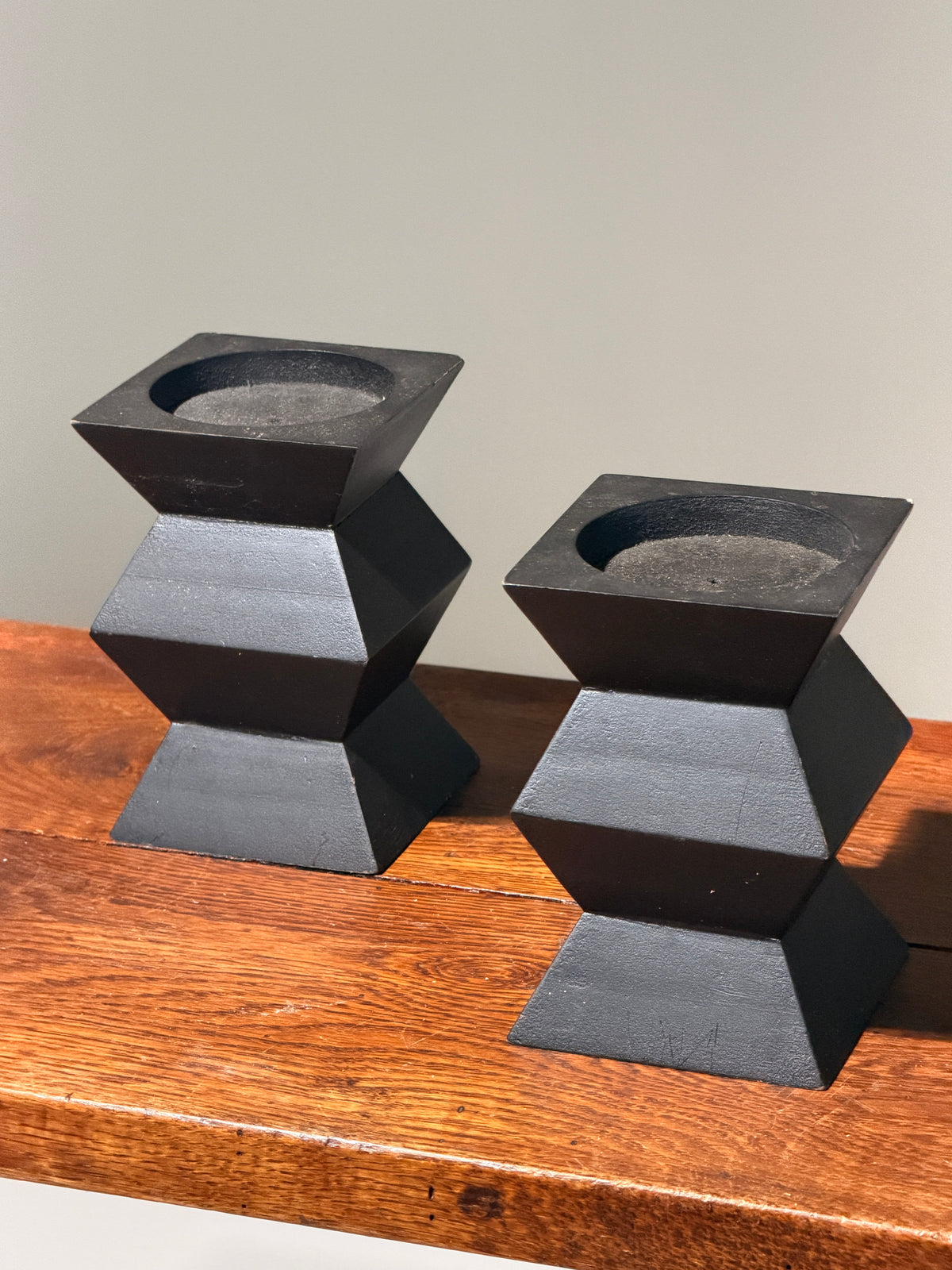 Pair of geometric black wooden candlesticks, anonymous work — side angle