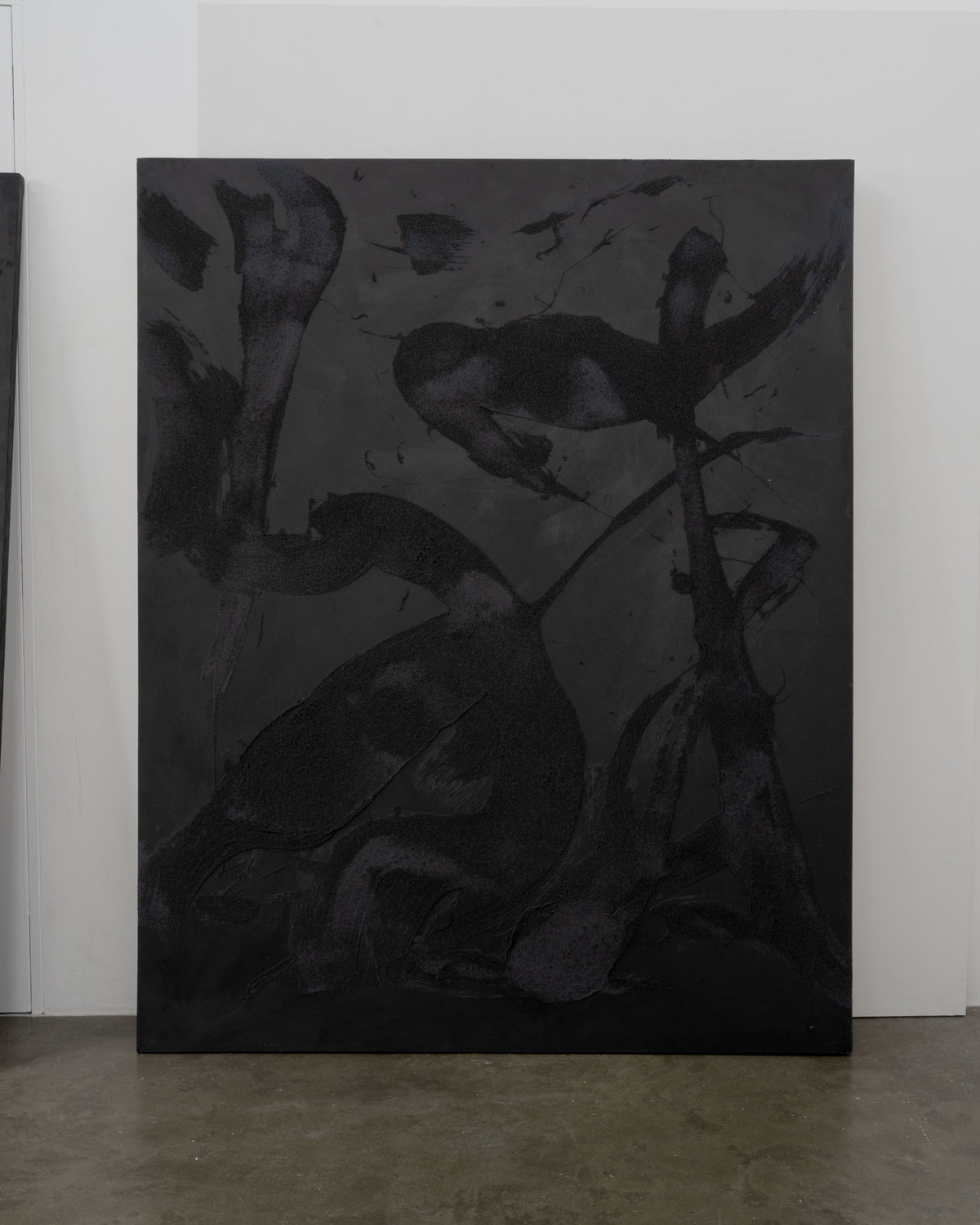 Abstract mixed media canvas with dark charcoal forms and gestural marks