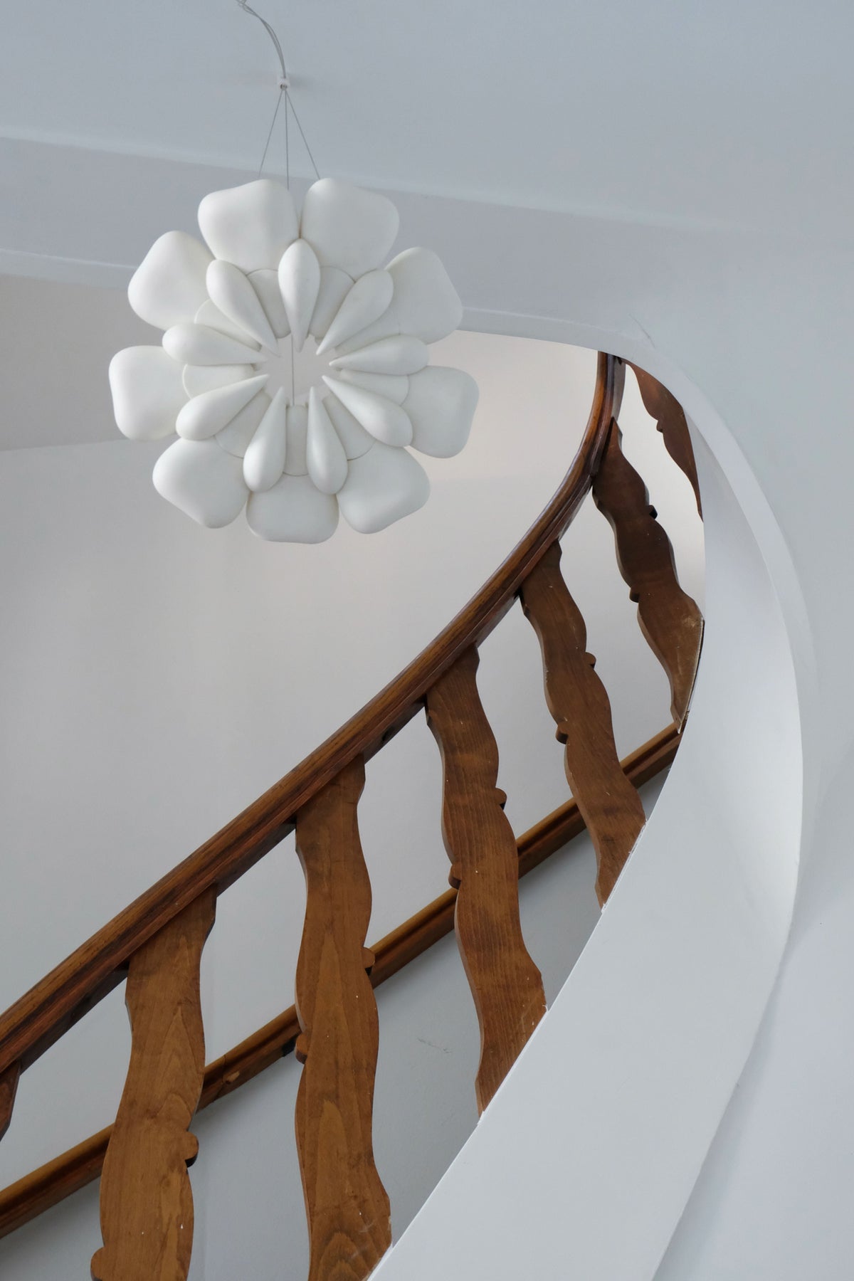 Pelagi' Pendant Light — hanging above wooden staircase in modern interior