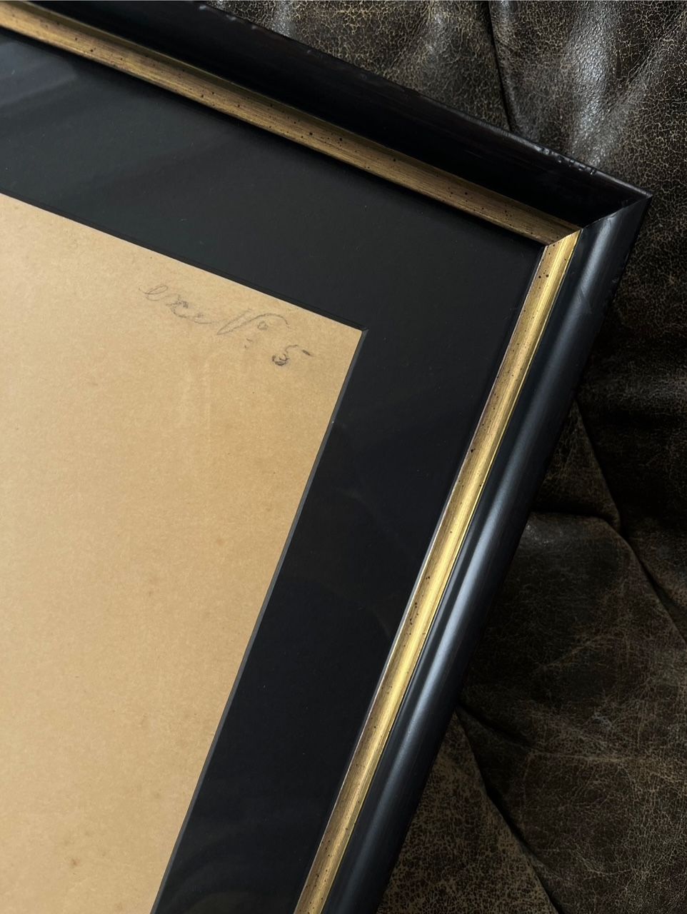 Figure Drawing in Pencil, Male Nude — angled view of black frame on leather