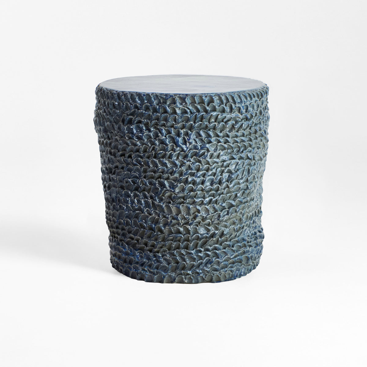 Casa Ceramic Side Table — textured blue ceramic surface in minimalist setting