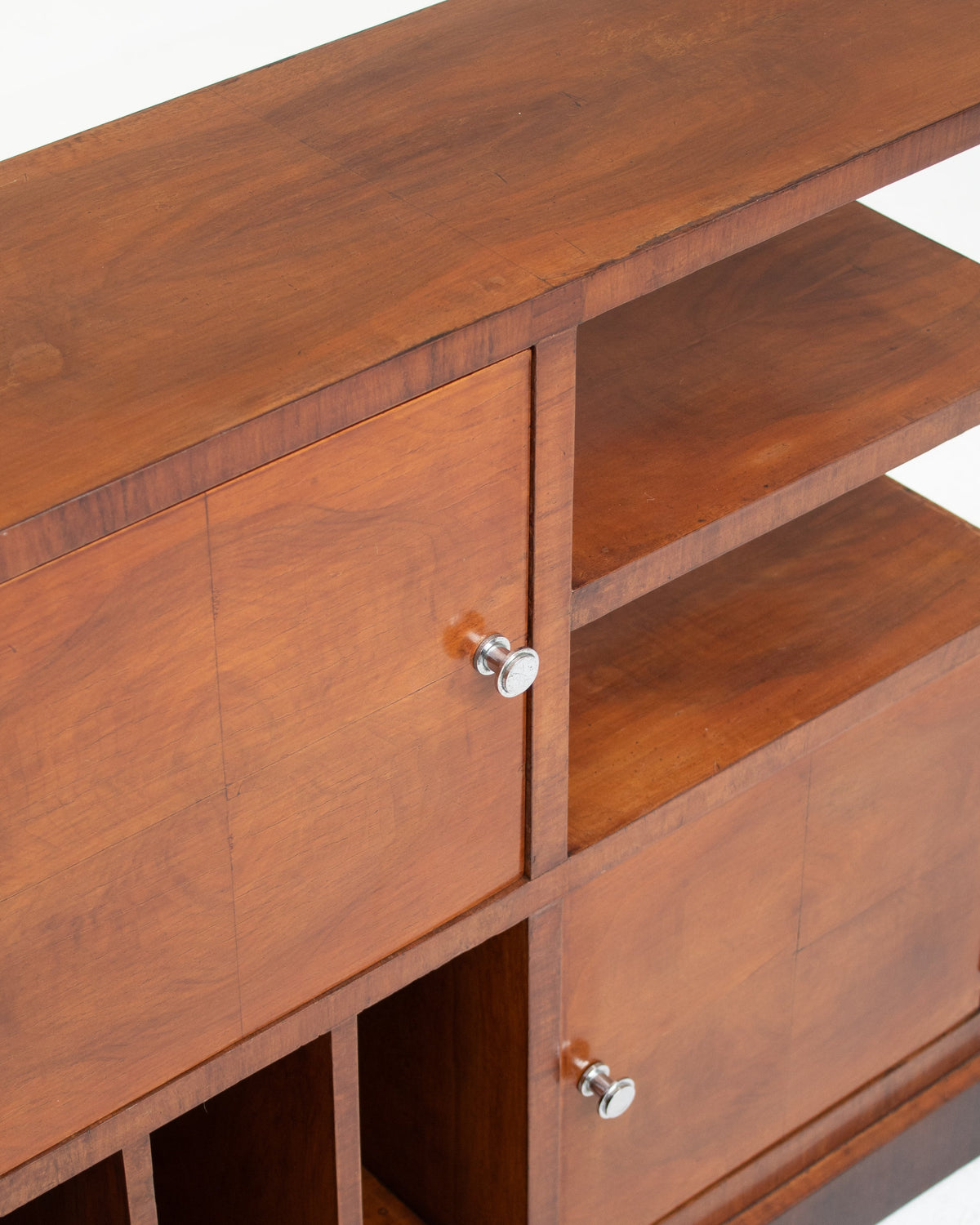 Art Deco cabinet detail showing cherry wood grain and chrome knobs