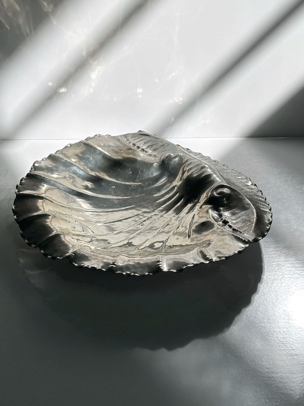 Handmade tin shell bowl artistic detail with textured surface