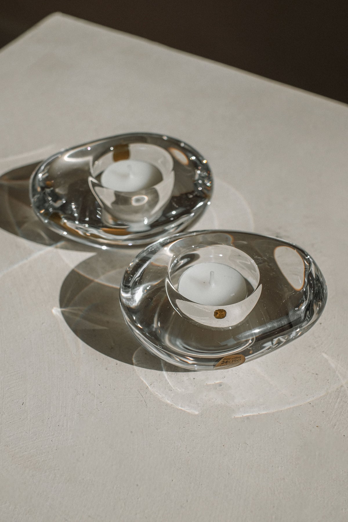 Clear crystal tealight holders with white candles, detail view