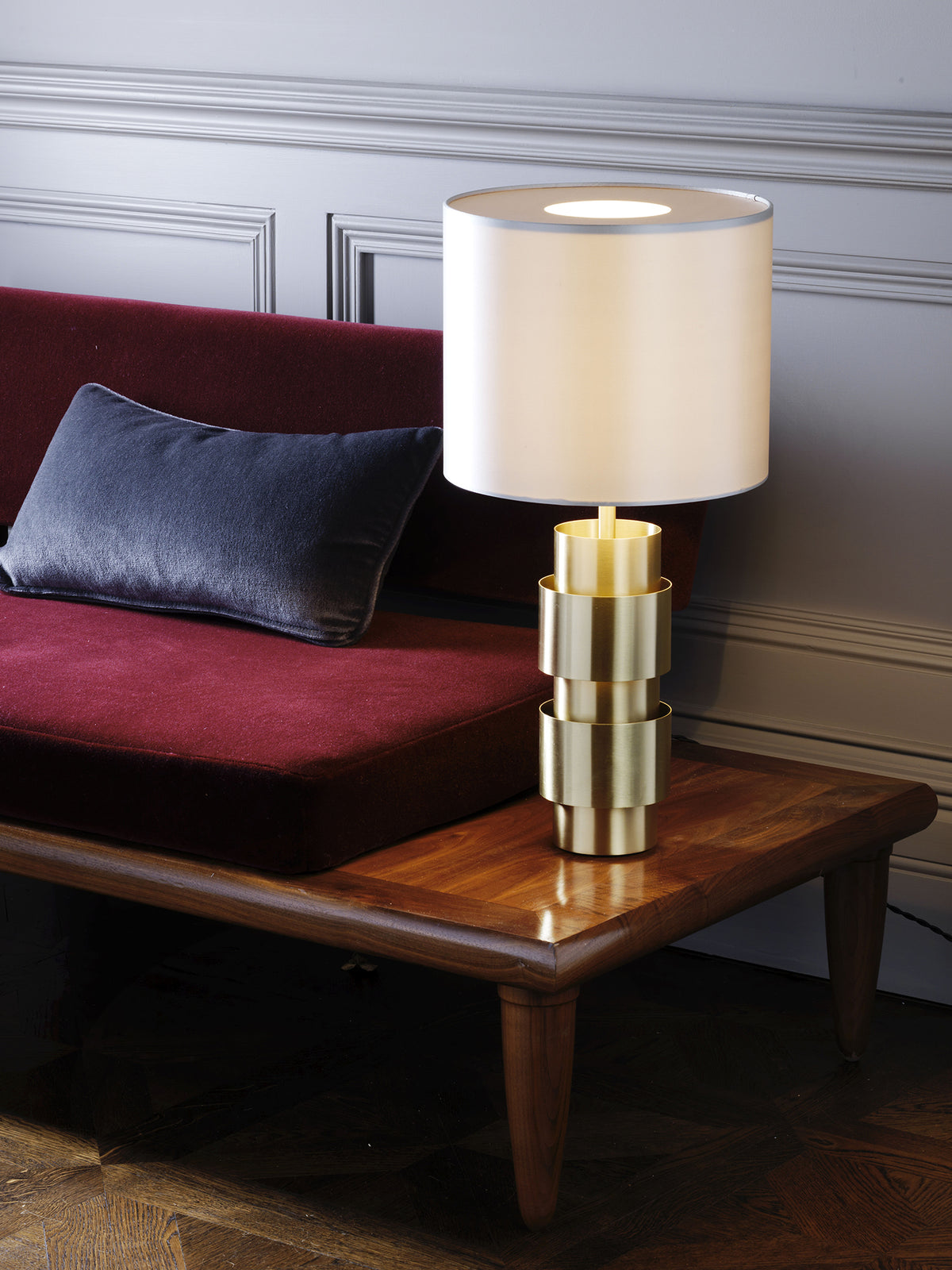 RING Table with Dove Grey Silk Shade — positioned on wooden table beside burgundy sofa