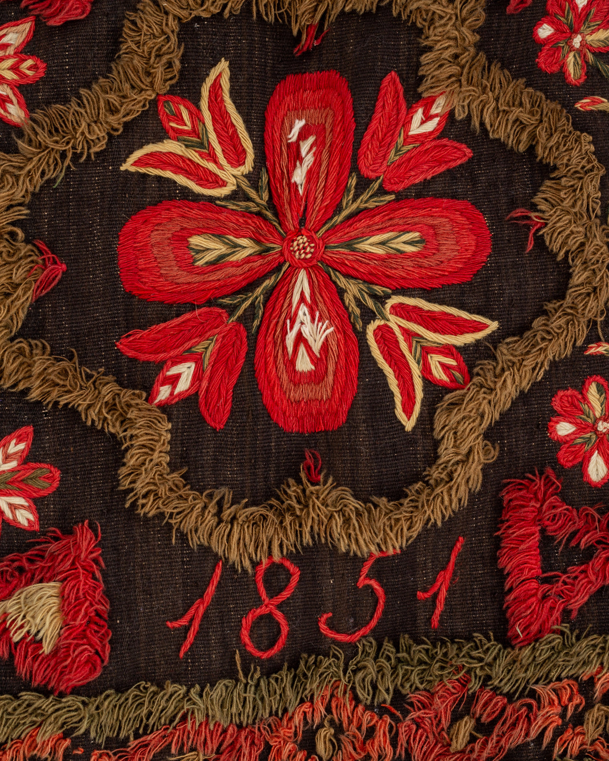 Embroidered red floral motif detail on 1851 Swedish wedding tapestry