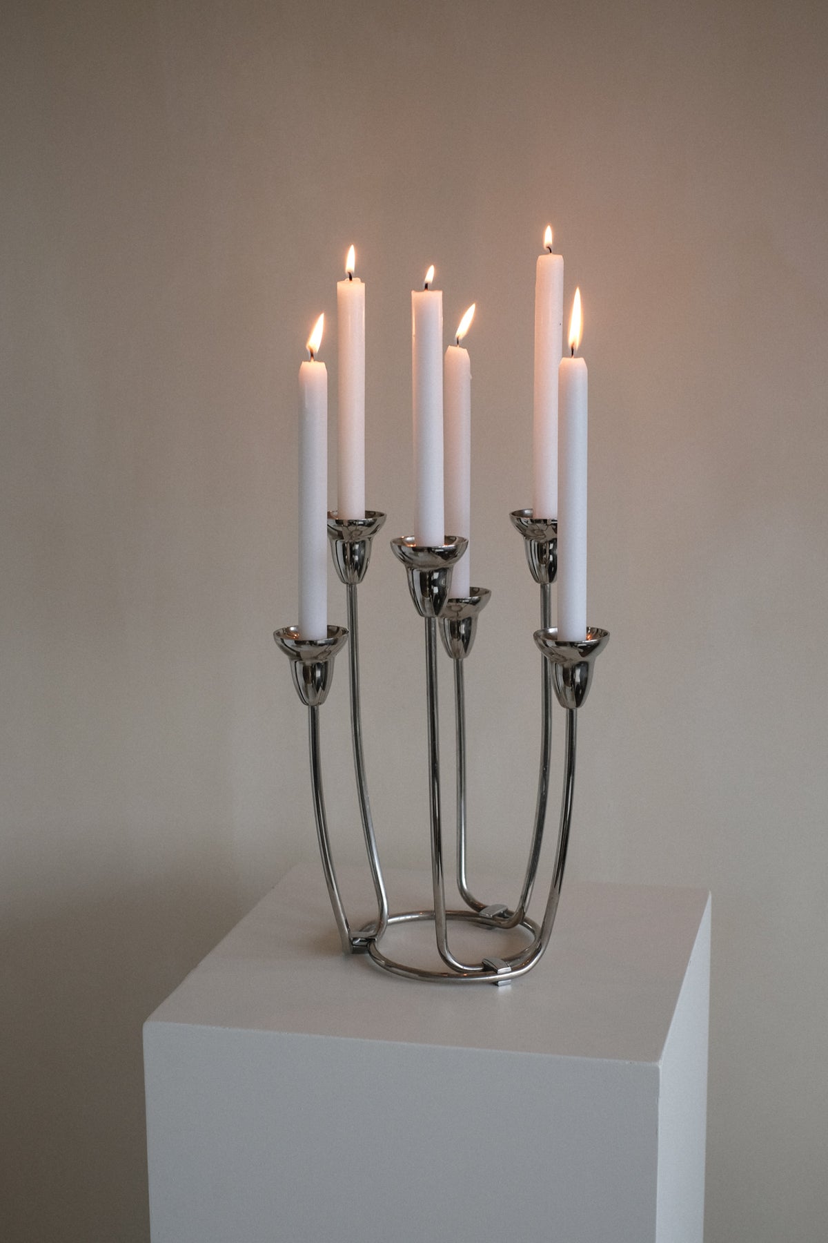 Large Candleholder — close-up of polished metal with lit candles