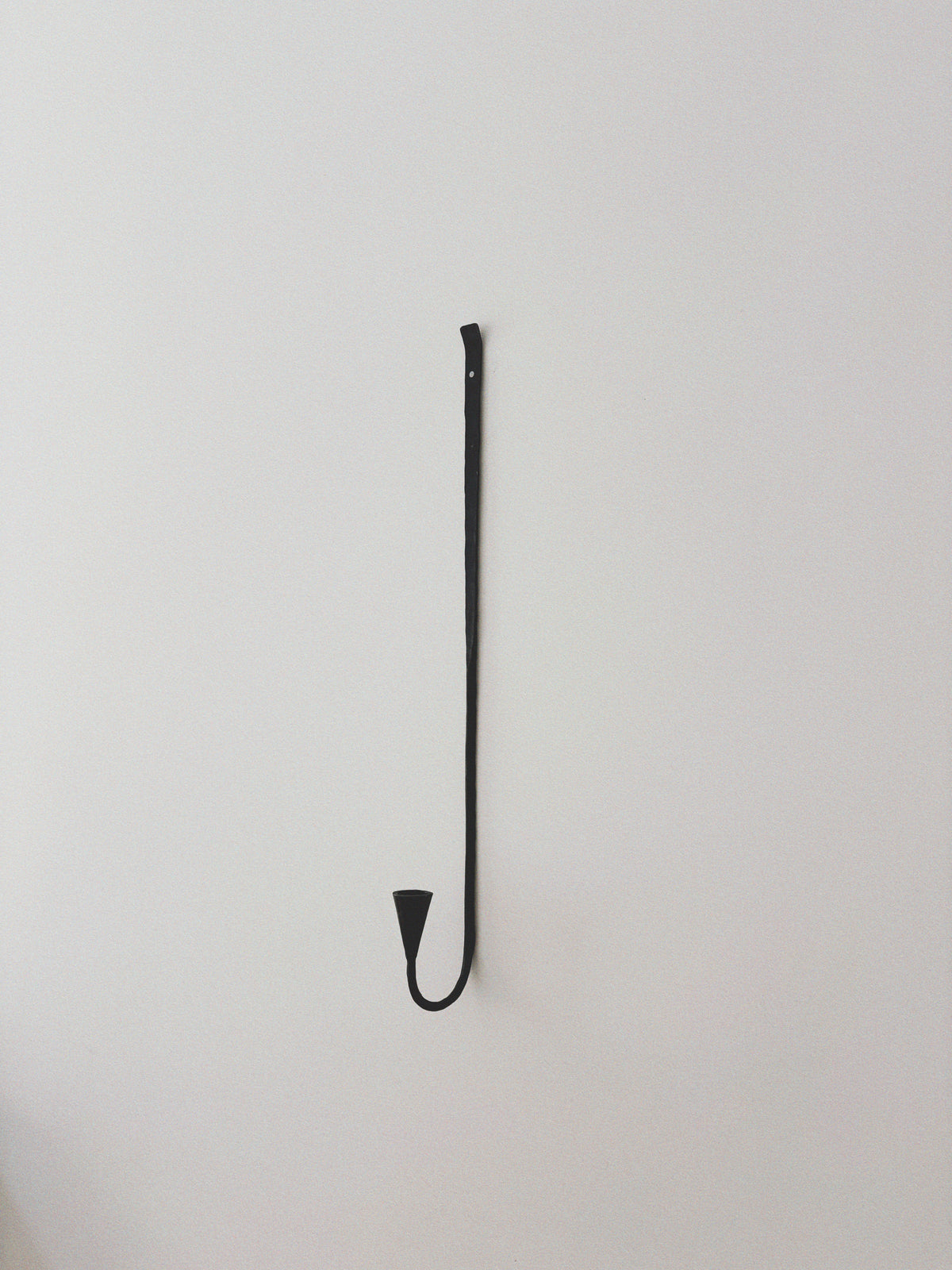 Set of 3 Large Danish Wrought Iron Wall Candlesticks, c. Late 1990s — close-up of black wrought iron candlestick on wall