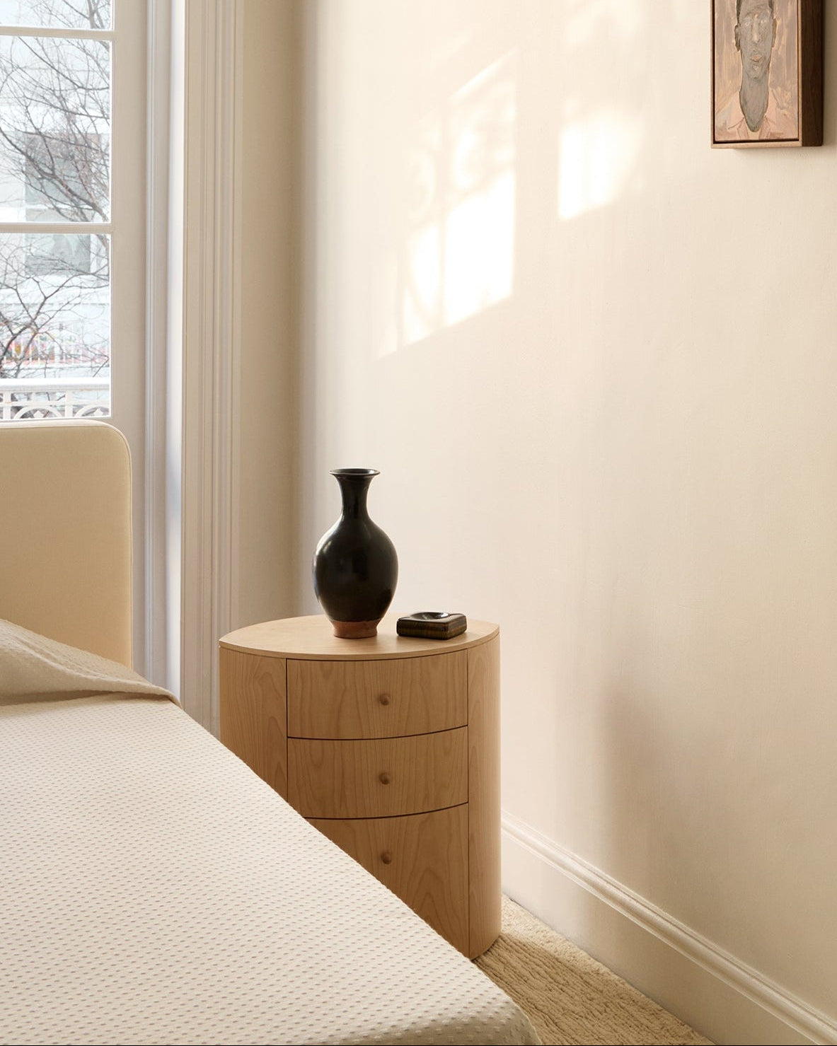 Observer natural birch nightstand with dark ceramic vase in bedroom