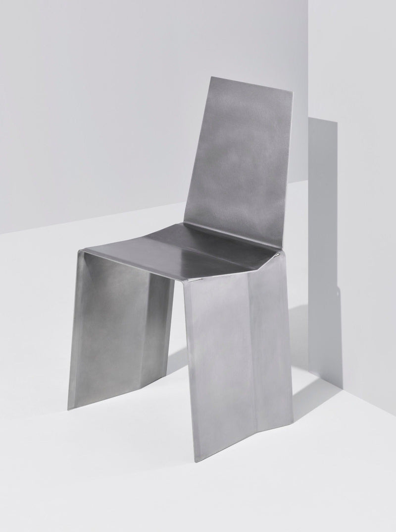 Modern angular chair in polished stainless steel by Paul Coenen