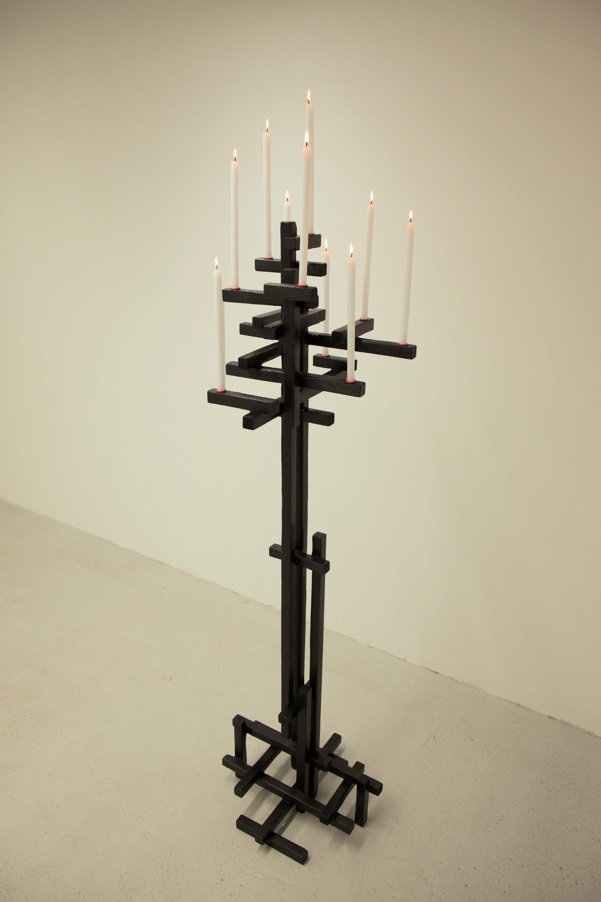TETRIS CANDELABRUM — tall black candle holder with lit candles