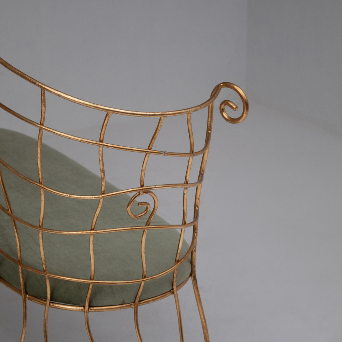 Sculptural Gilt Metal Bench with Green Upholstery — close-up