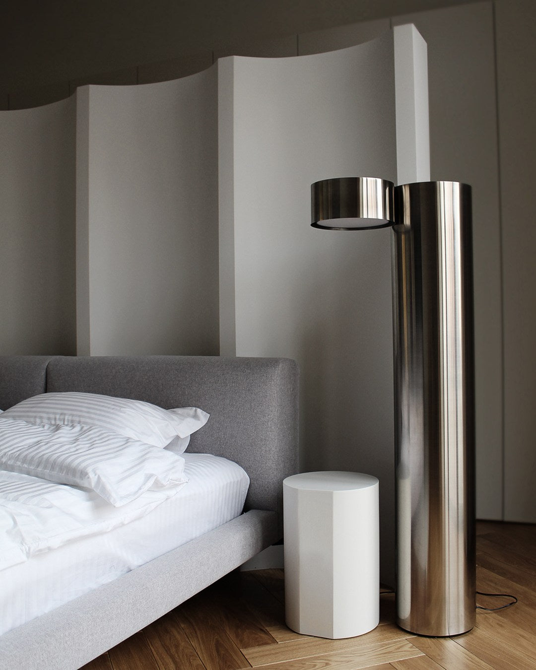 X floor lamp — modern stainless steel design beside bed