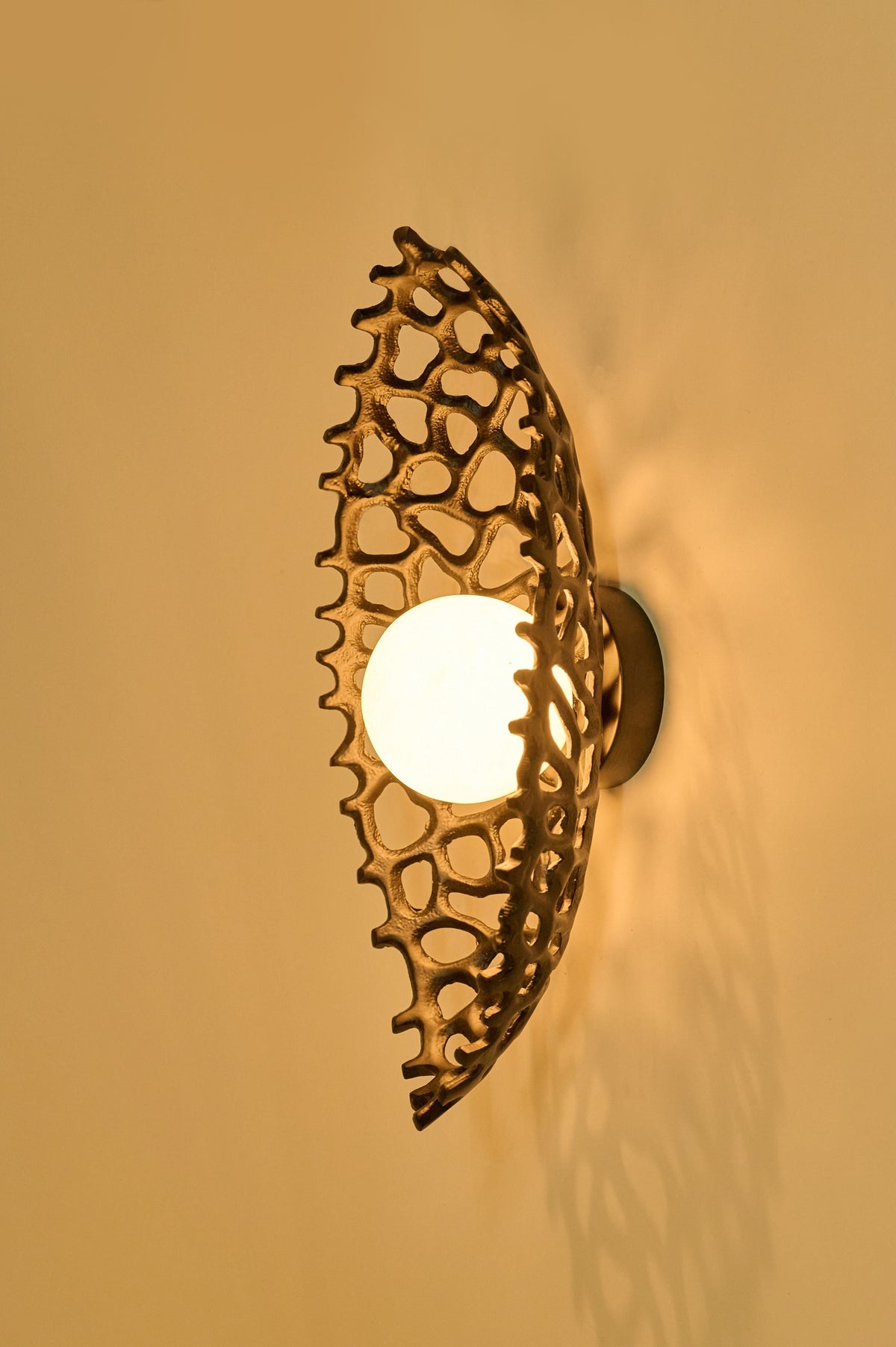 Ajna Sconce — wall-mounted lamp with textured brass shade