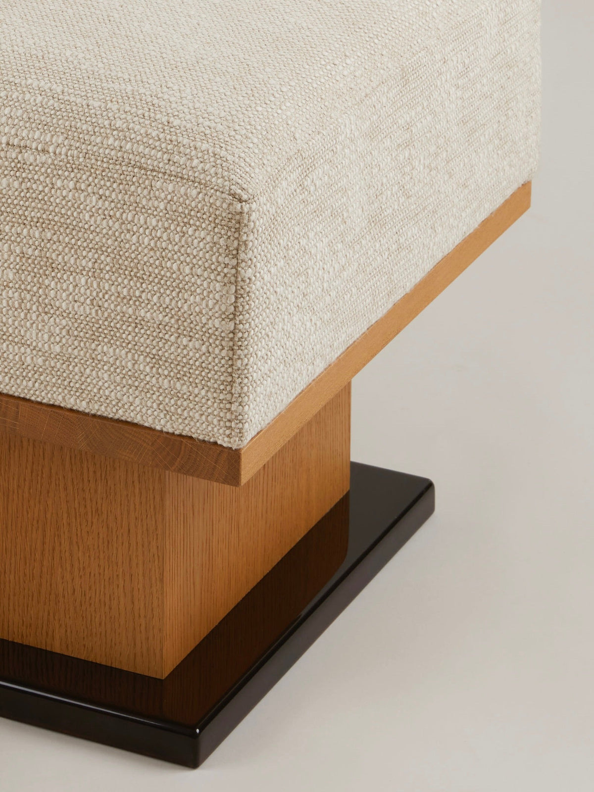 Sorbet Ottoman/stool in oak and lacquer — side angle showing wooden base and fabric top
