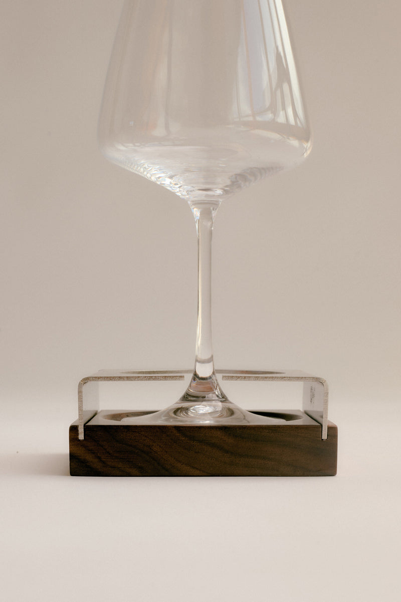 Clear acrylic coaster with wine glass on walnut wood base