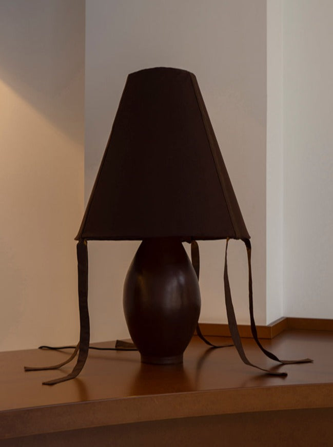 Brown ceramic table lamp with dark shade and leather ties, Los Objetos Decorativos