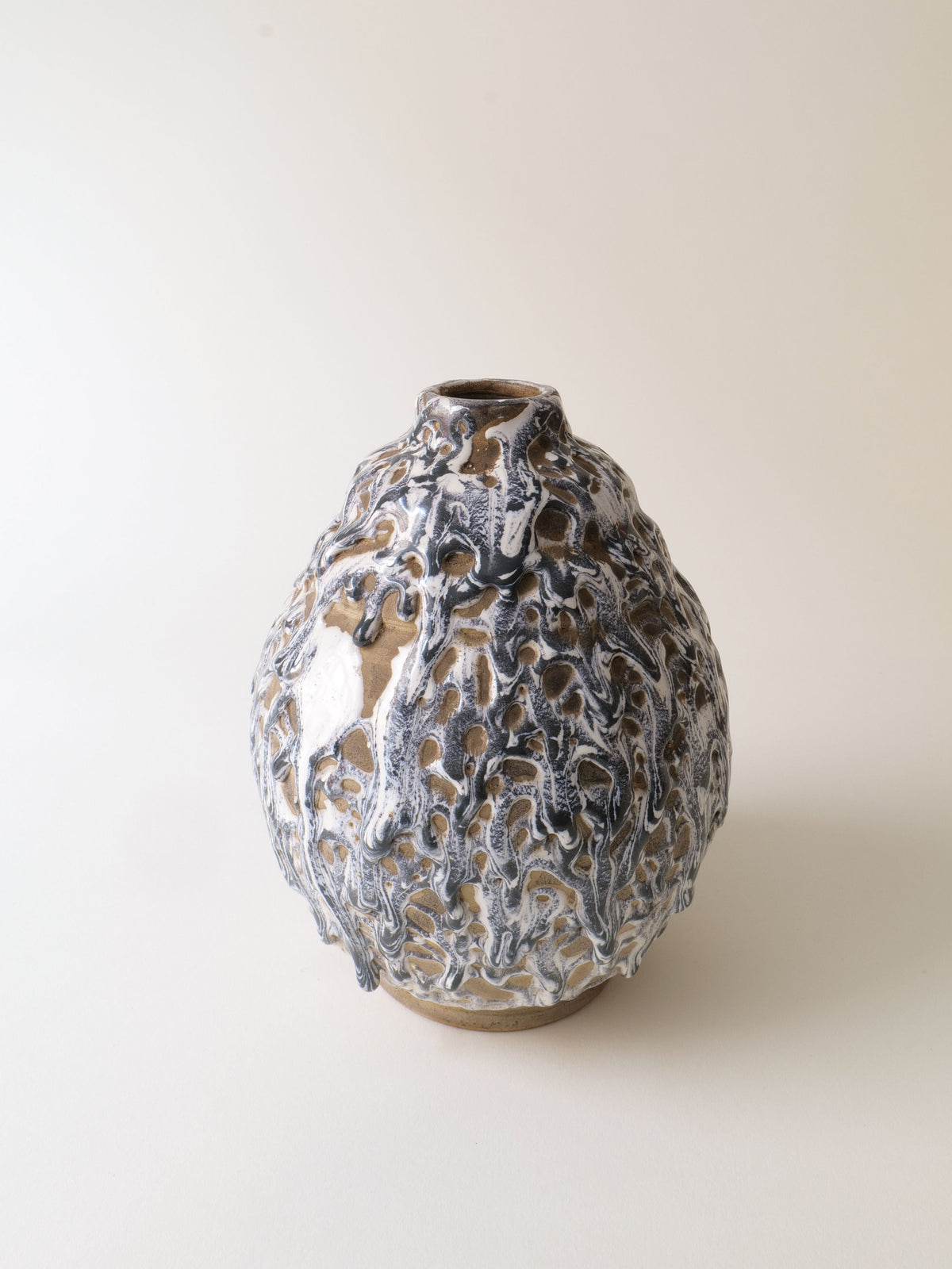 The Deco Ceramic Vase 1930s by Collection apart features a rounded stoneware design with a textured, dripped glaze in brown, white, and gray tones over a light neutral background.