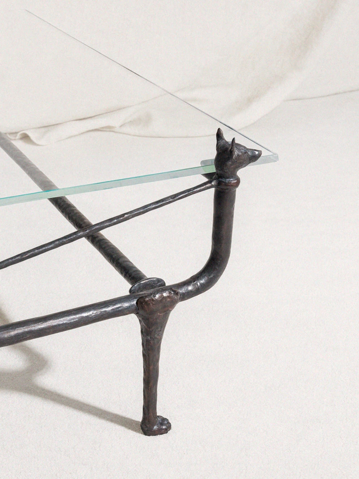 Loyal Bronze Dog Coffee Table — side angle showing bronze dog legs and glass top