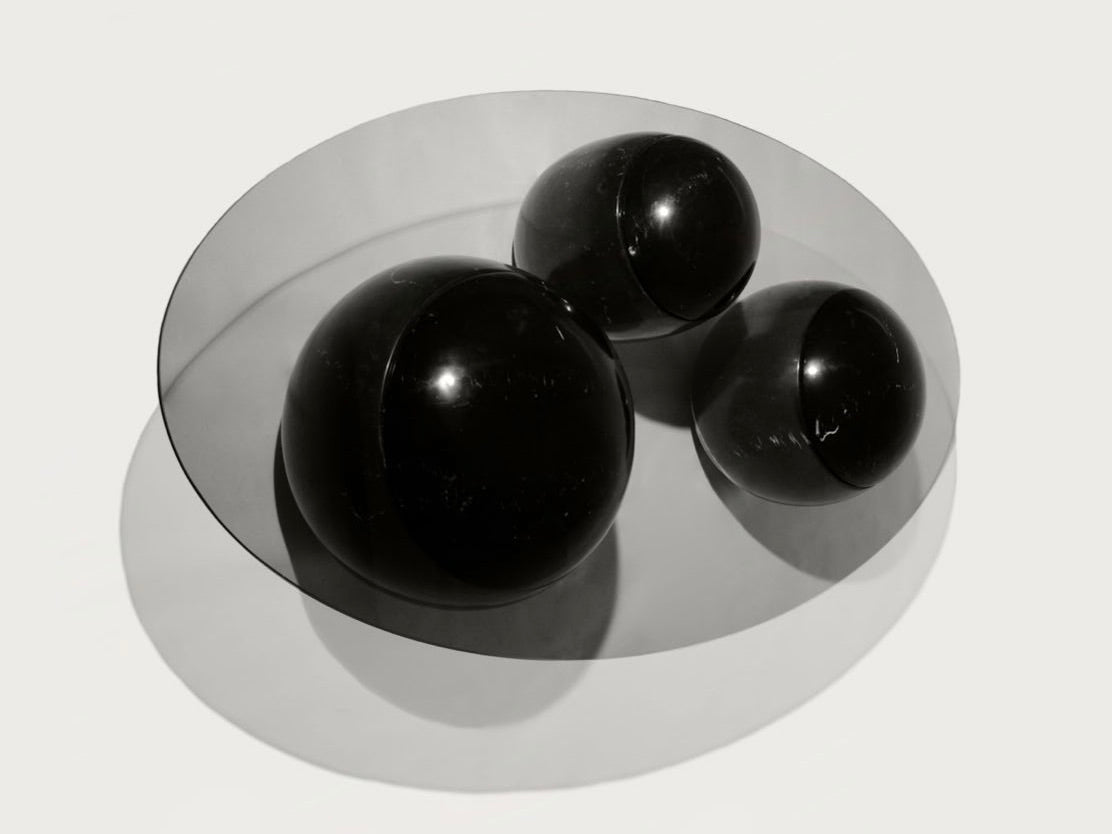 Ovni Uovo' Coffee Table — close-up of glossy black spheres on surface