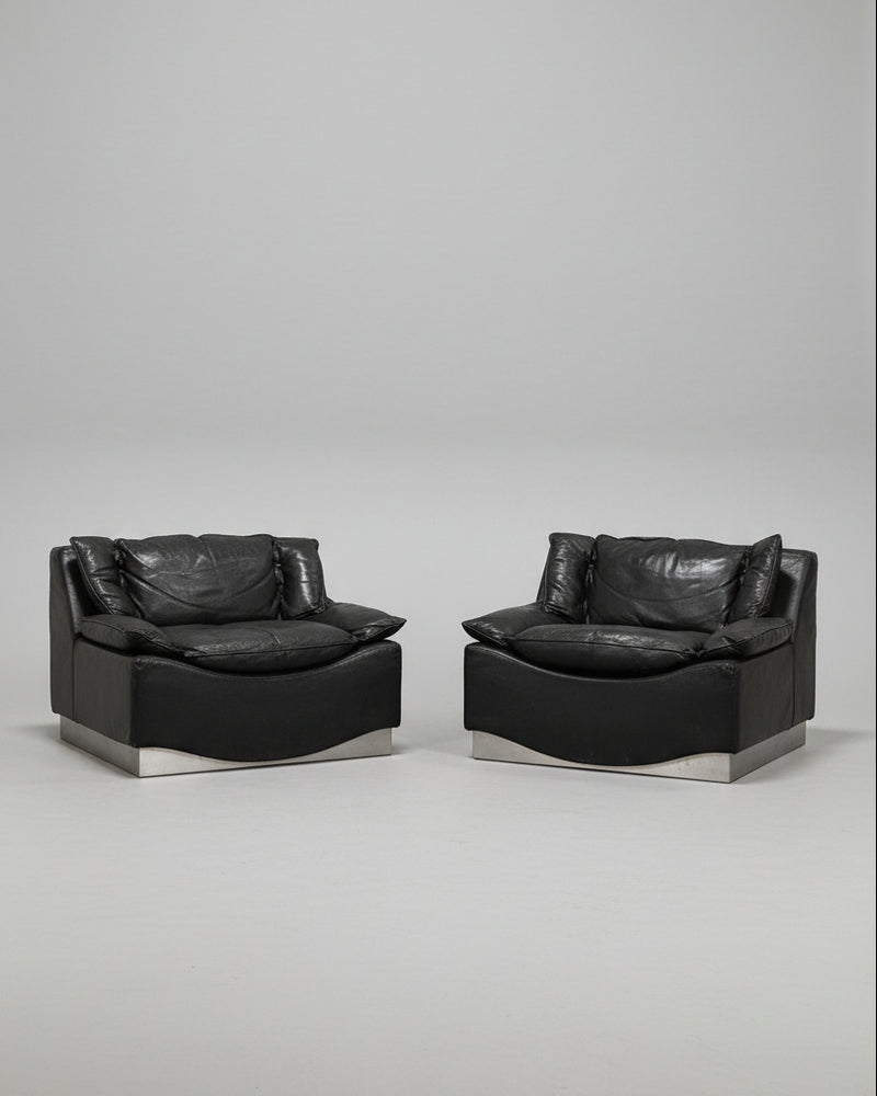 Pair of black leather armchairs with steel bases by Frigerio