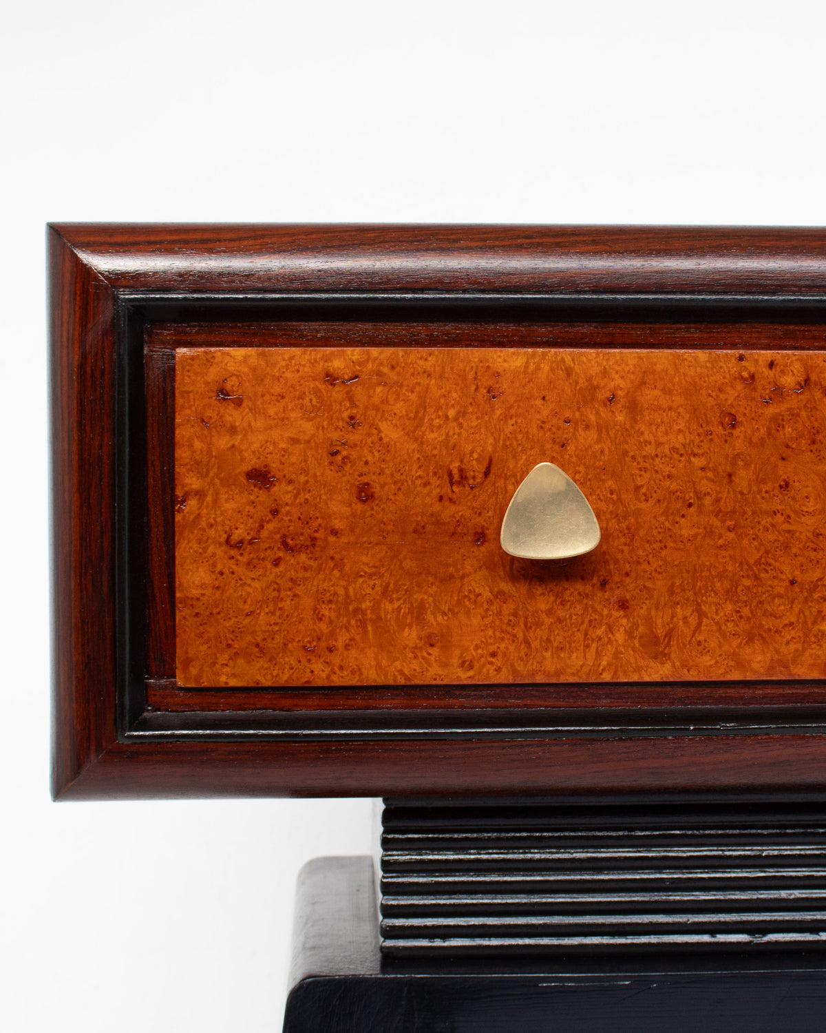 Close-up of Art Deco console drawer with burl wood veneer and brass knob