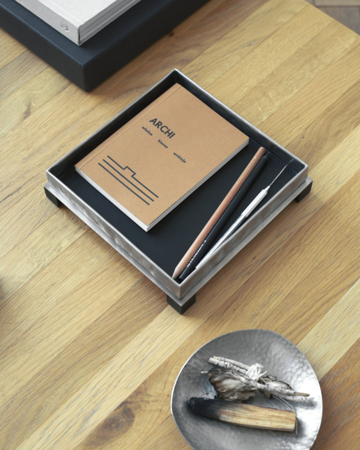 Yuma leather tray styled with notebooks and ceramic dish