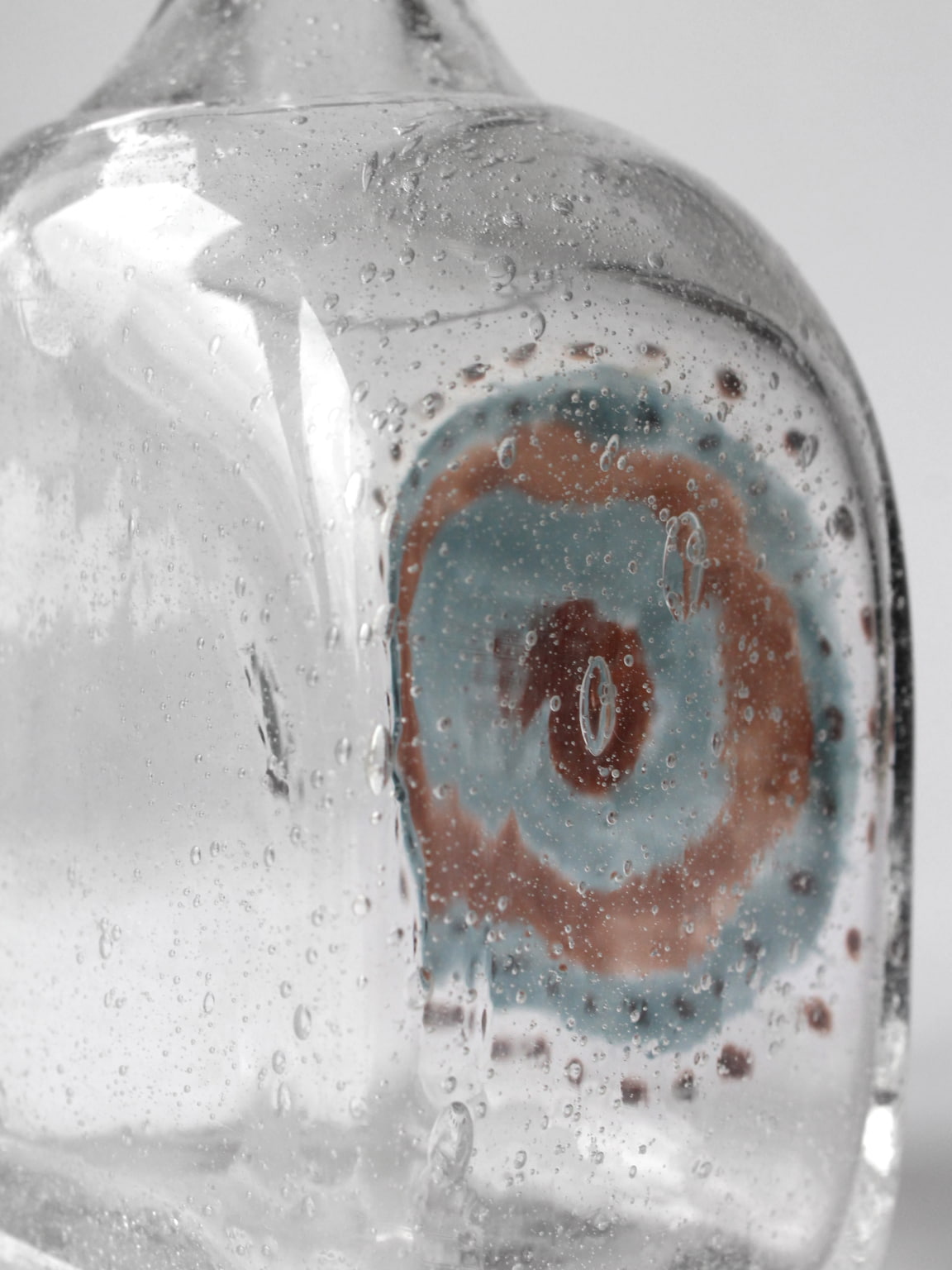 Bubble glass carafe interior detail showing layered abstract patterns