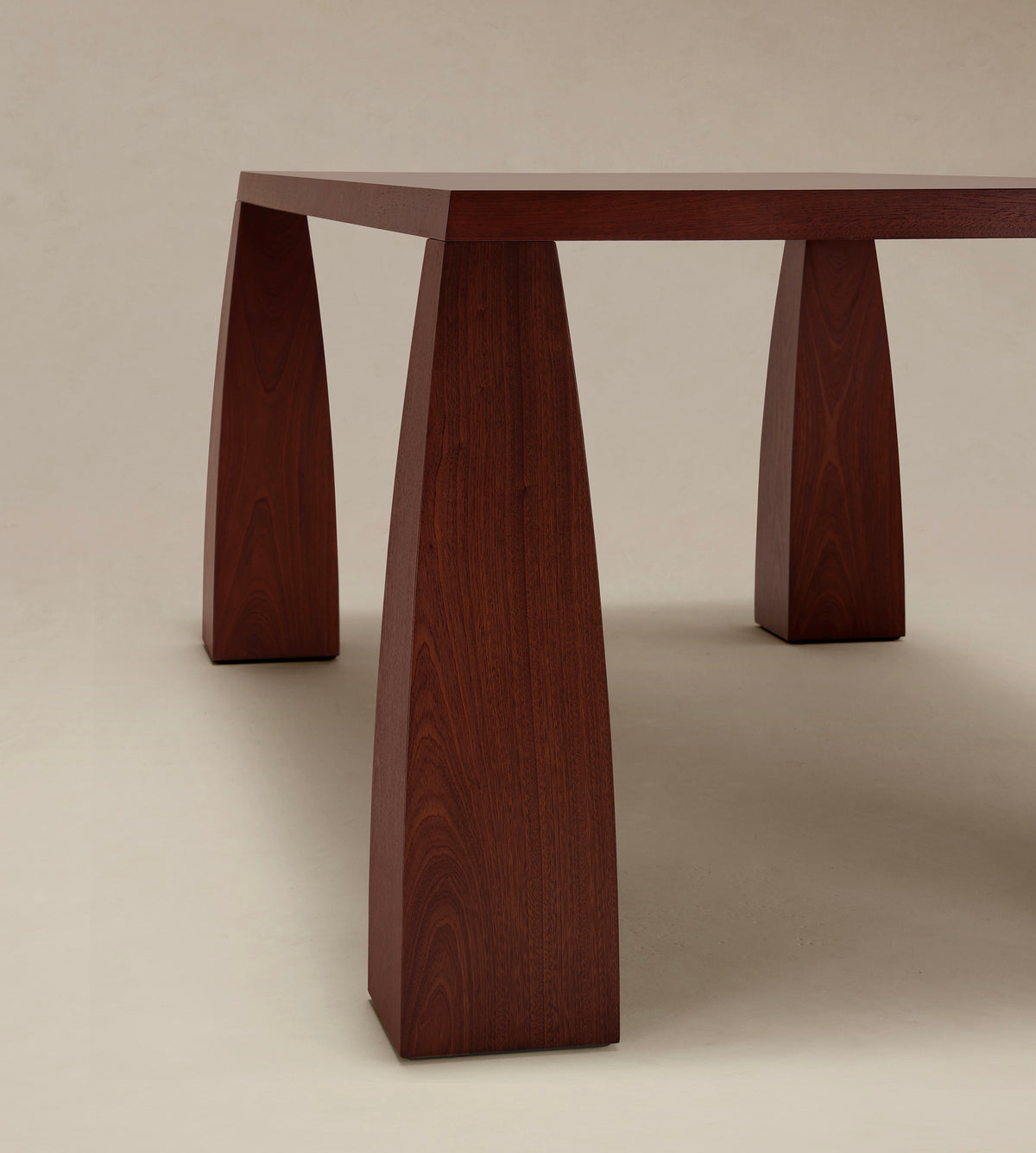 Khram Dining Table — side angle showing rich wooden legs