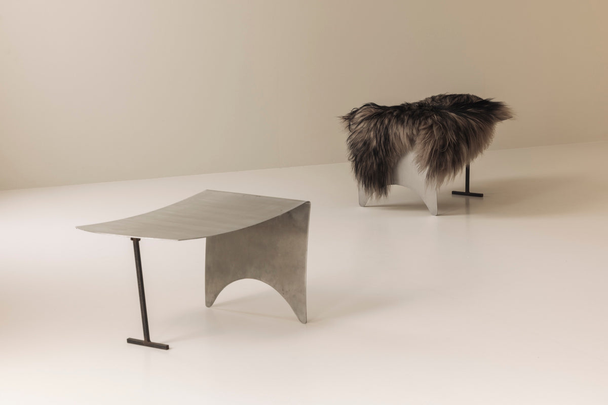 A striking set Modernist curved metal stools from France, dating to the 1980s. — lifestyle setting