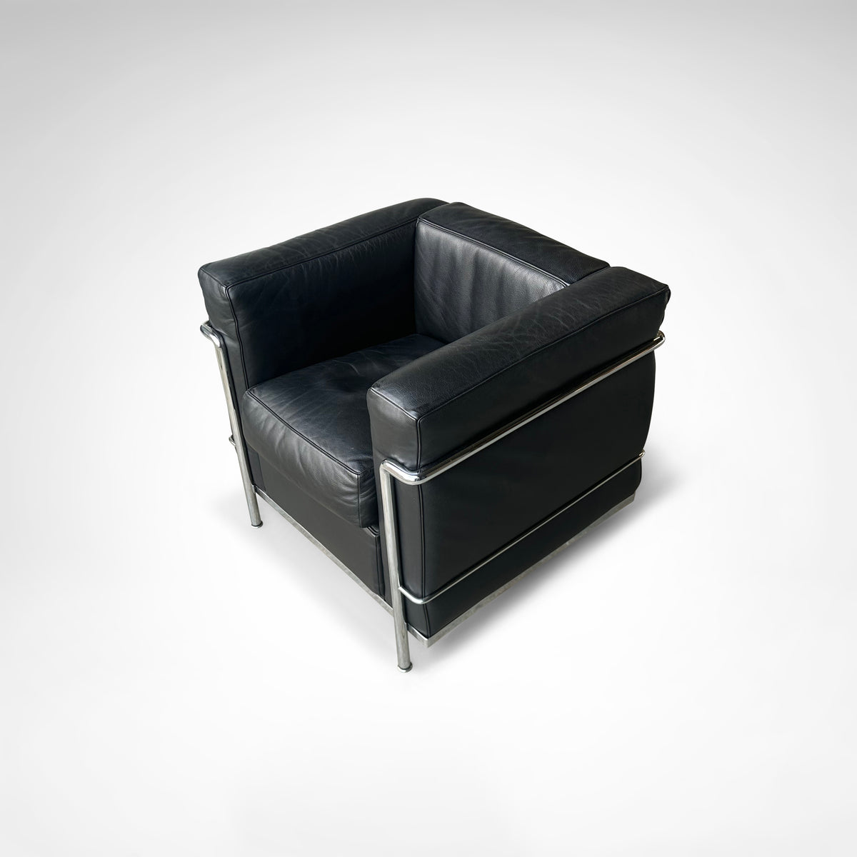 LC2 Armchair and Ottoman by Le Corbusier et al. for Cassina 1990s — close-up of black leather upholstery and chrome frame