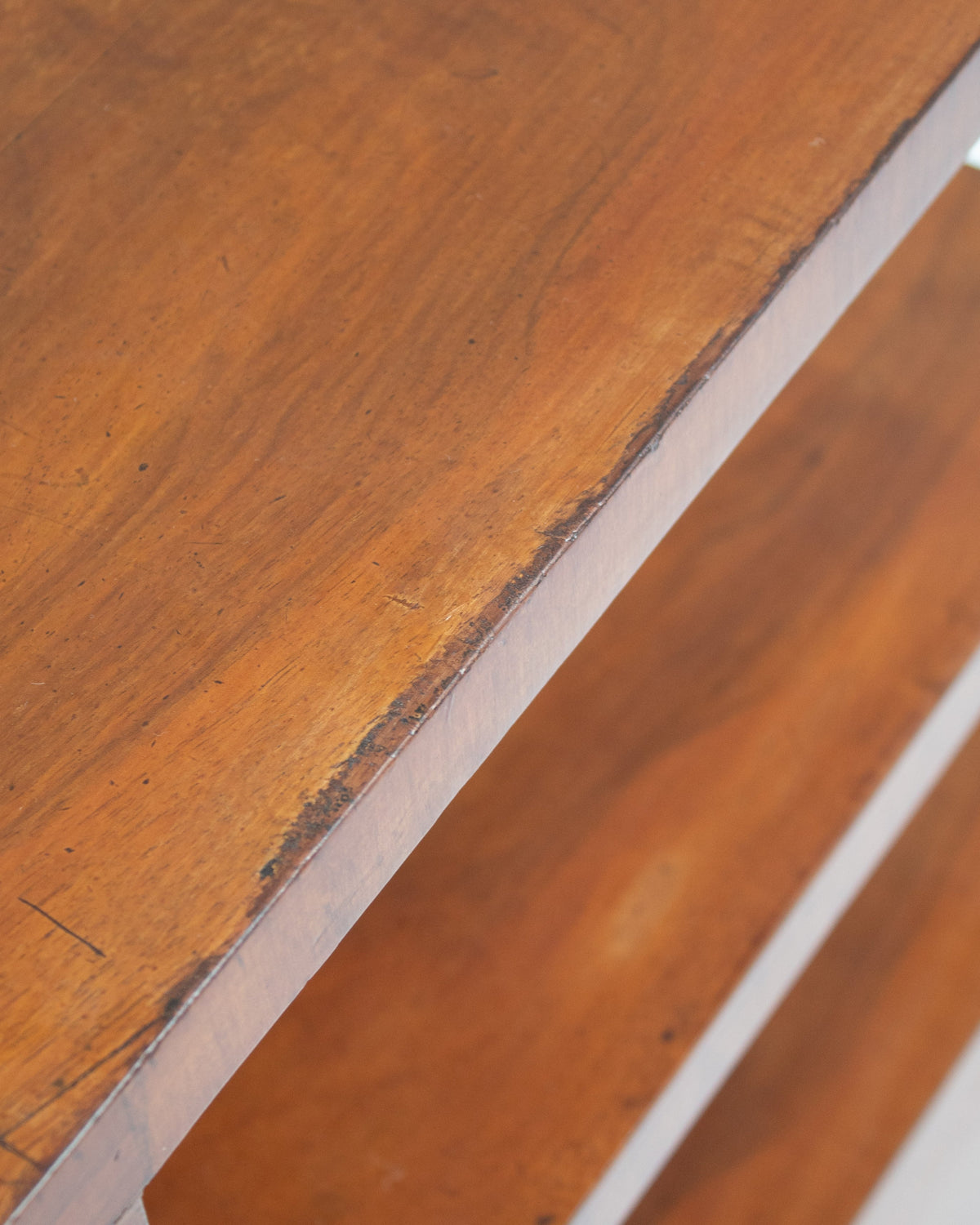 Edge detail showing wood grain and white trim of Art Deco cabinet