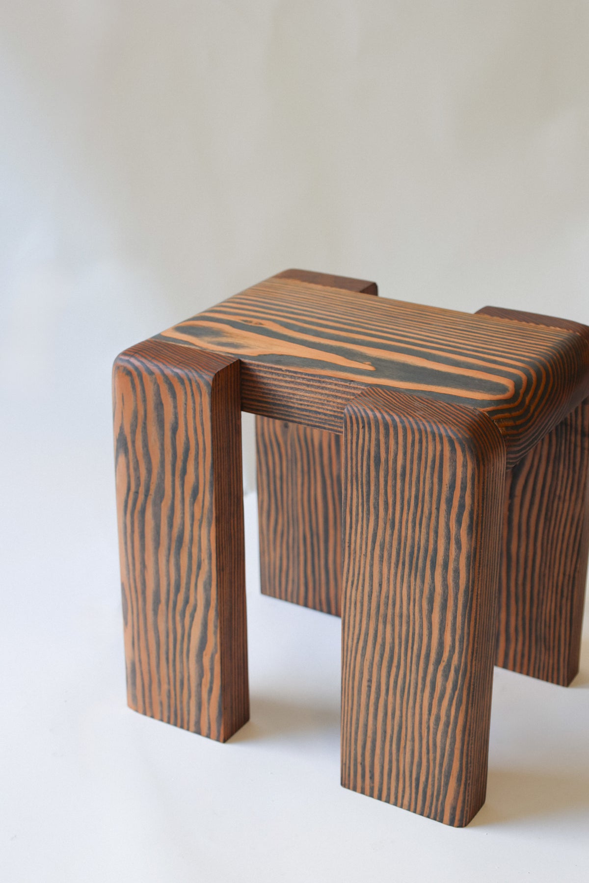 Douglas fir milking stool with distinctive wood grain pattern