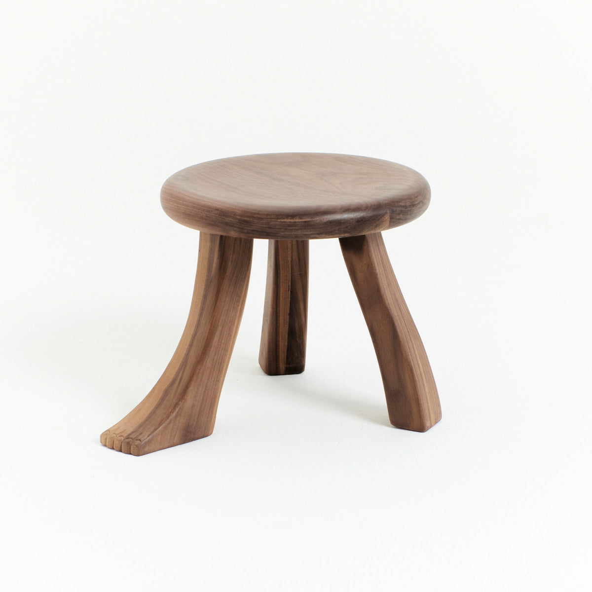 Foot Stool in Black Chestnut — angled view highlighting curved wooden legs