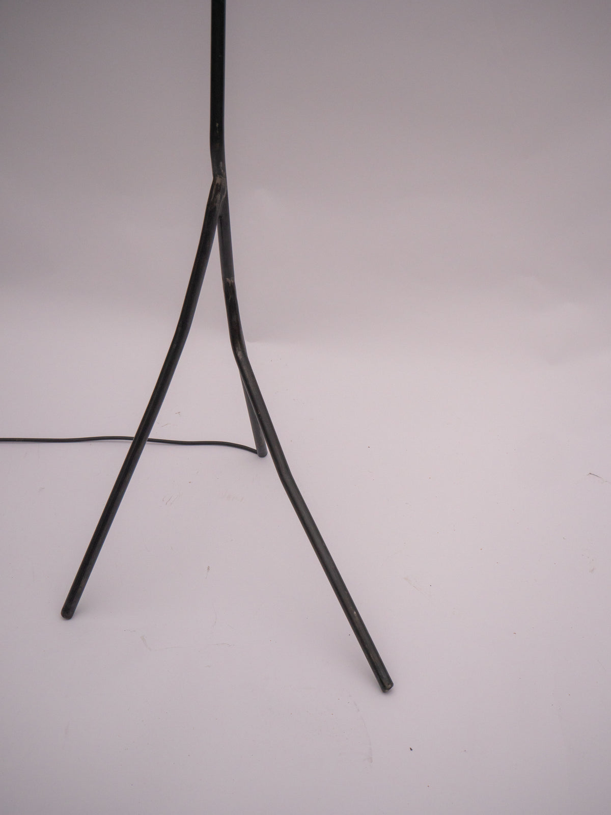 Base detail of Balancing Act floor lamp with tripod legs